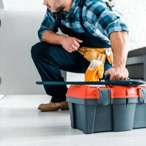 cropped-view-of-bearded-handyman-sitting-and-holding-toolbox.jpg